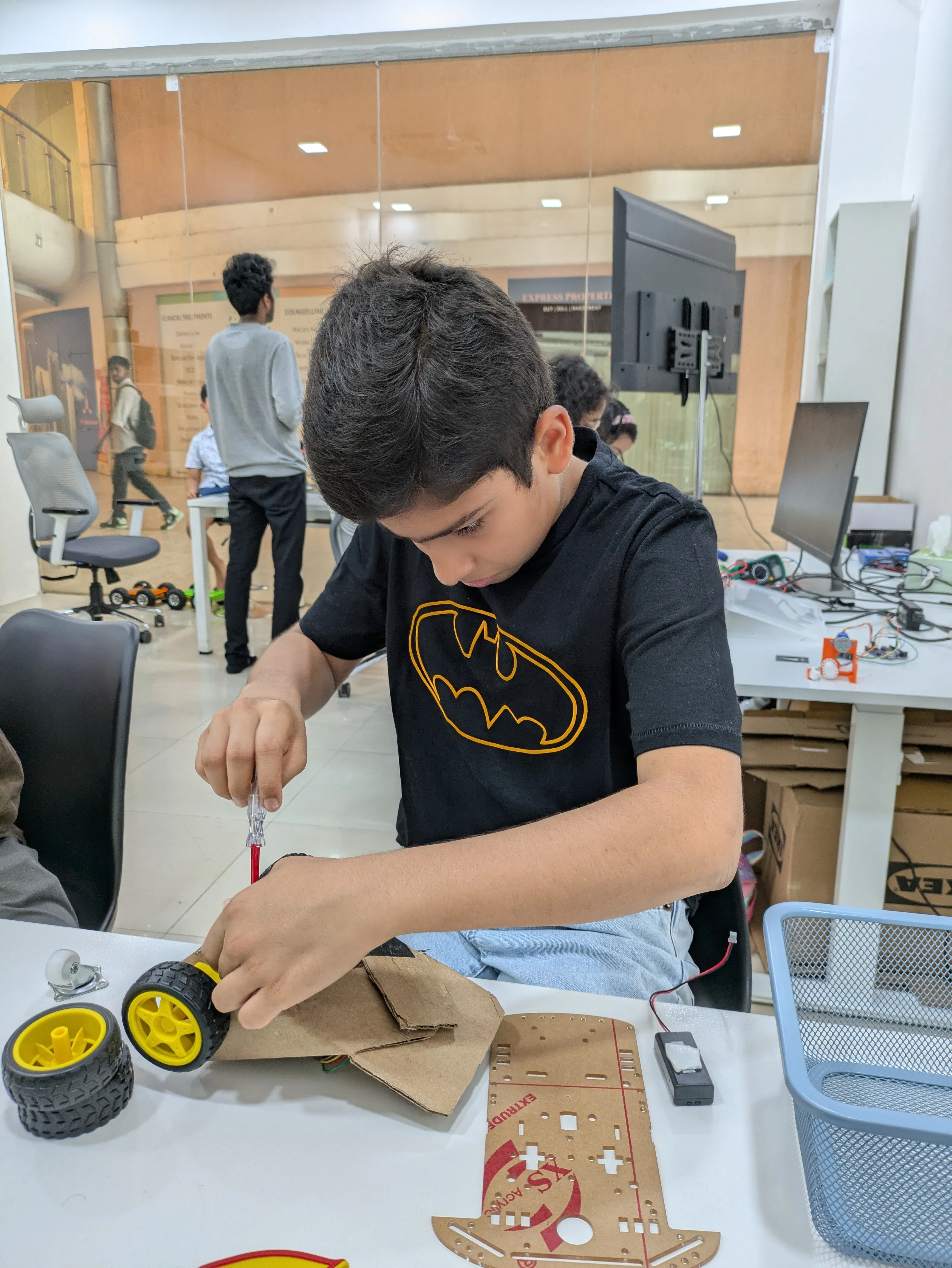 Student building a hackathon robot